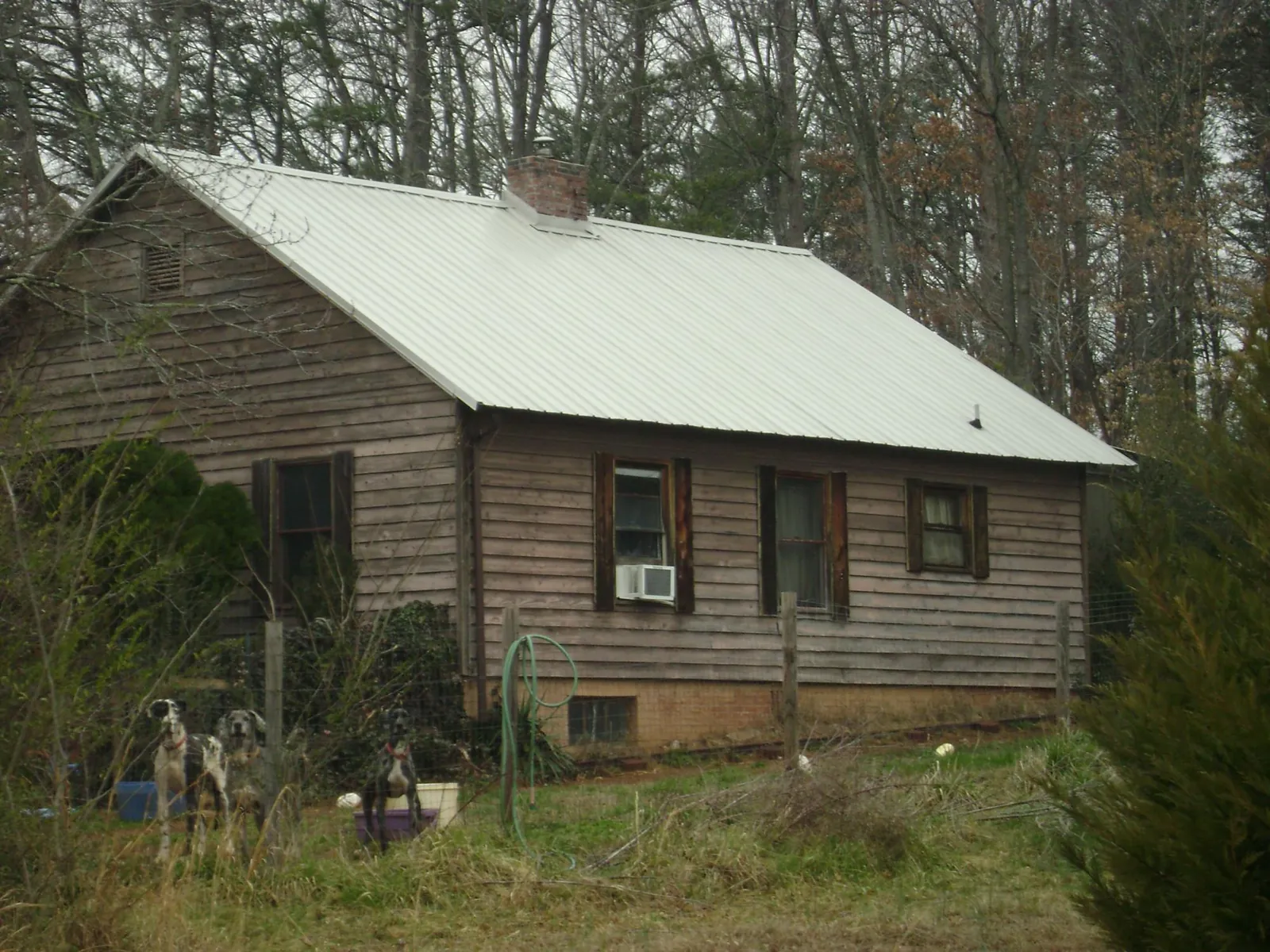 White metal roof on an old wood sided farmhouse, from a Metal Roof Installation job in Grand View